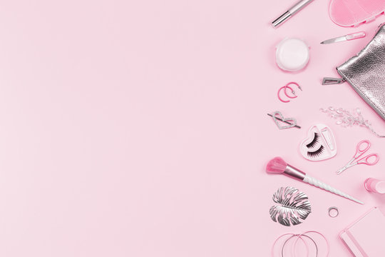 Tender pink monochrome feminine makeup tools and silver accessories. brushes eye lashes vanish on candy pink. Flat lay, birthday beauty cosmetics blogger advert border concept. Heart, love hair clips
