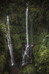 Beautiful high waterfall Sekumpul in tropical forest on Bali in Indonesia as famous landmark