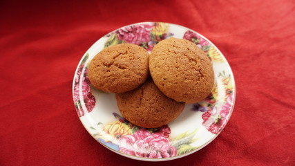 cookies on plate and a red background