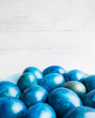 blue eggs with a tint on a white background for Easter