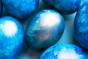 blue eggs with a tint on a white background for Easter
