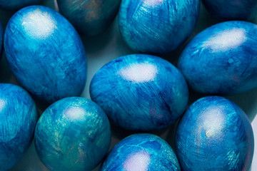 blue eggs with a tint on a white background for Easter