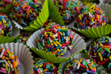 Truffles with colorful colors. Selective focus.Sweet food for birthdays. Truffles in his cap