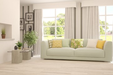 Naklejka premium Stylish room in white color with sofa and summer landscape in window. Scandinavian interior design. 3D illustration