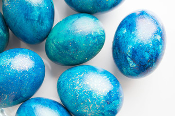 blue eggs with a tint on a white background for Easter