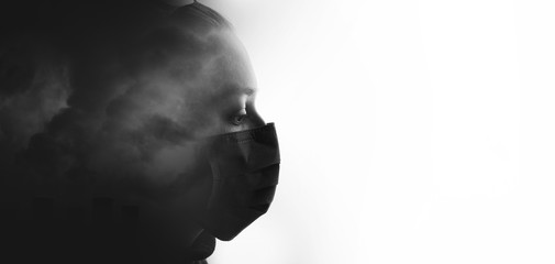 Double exposure of female face and  polluting air. Portrait of young sad woman in protective respirator. Girl wearing medical mask. Free space for text.