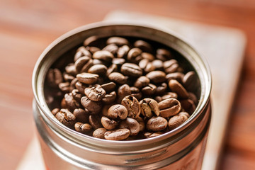 Coffee beans in a can. Roasted aromatic coffee close-up. Sunlight on background