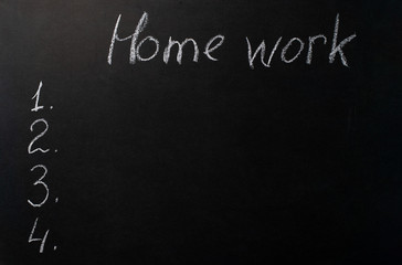the inscription "homework" written in white chalk on a black chalkboard. Template for listing list.