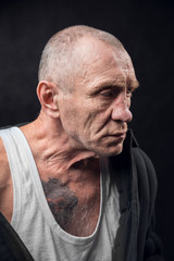 Closeup portrait of an old man on a black background