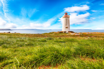 Fototapeta na wymiar Stunning view of Skarsviti lighthouse in Vatnsnes peninsula on a clear day in North Iceland.