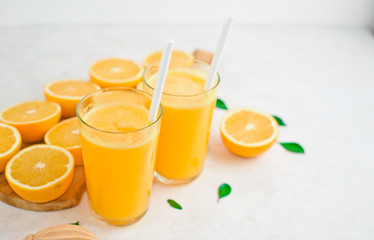 fresh orange Juice and oranges on the cutting board