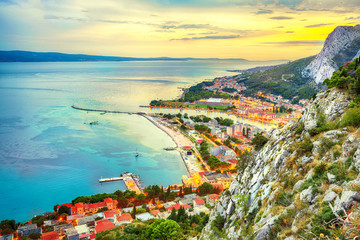 Beautiful aerial panoramic view of Cetina river, mountains and Old town Omis at sunset