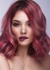 Fototapeta premium Beautiful girl with multi-colored hair and classic make-up and hairstyle. Beauty face.