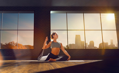 Yoga woman. Young woman doing yoga in loft on sunrise.