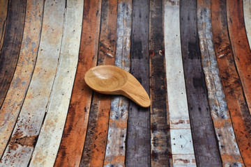 A small brown spoon made of wood