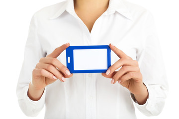 Female hands showing blank bagde on white background