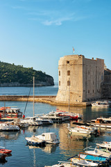 Fototapeta na wymiar St John Fortress and boats in Old port in Dubrovnik