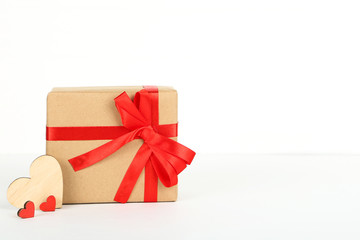 Gift box with ribbon and hearts on white background