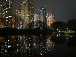 Obraz premium Night city in colorful lights and reflection in water, Kyiv Ukraine.