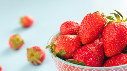 strawberries in a colorful bowl on a colorful background