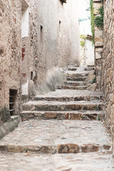 Fototapeta premium Stone steps up on a narrow street in an old European city in Spain.