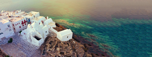 Aerial drone ultra wide photo of famous whitewashed chapel of Paraportiani in Little Venice area,...
