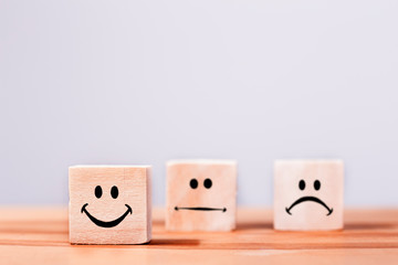 Emoticon icons face on Wooden Cube , Costumer service concept 