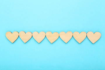 Brown wooden hearts on blue background