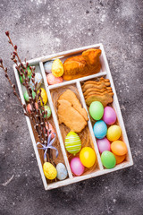 Box with Easter cookies and eggs