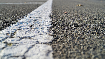 white road marking on an asphalt road