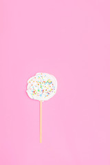 Homemade zephy or russian marshmallow on a stick on soft pink background. Top view, flat lay