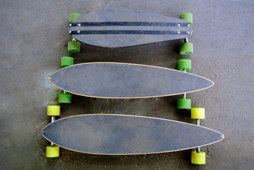 Longboards are on the pavement. Two boards of different sizes. Top view on walking skateboards....