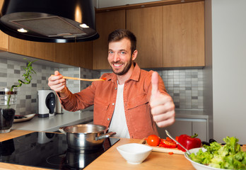 Shot of a handsome young man cooking in kitchen