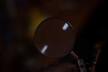 Magnifying insole. Device for enlarging an object placed under a magnifying glass. Frame in the style of a detective story and examination of evidence under a magnifying glass.