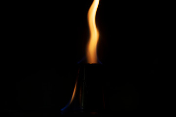 Flame texture on a dark background. The tongue of the flame is warm.