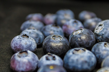 Blueberries closeup (Vaccinium myrtillus) on a black blackground, common bilberry closeup - Image