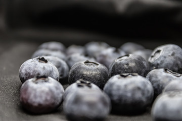 Blueberries (Vaccinium myrtillus) on a black blackground, common bilberry or blue whortleberry closeup - Image