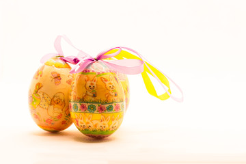 A symbol of the Easter celebration, with Easter bunnies and Easter eggs and white feathers, to be used as wallpaper or postcard