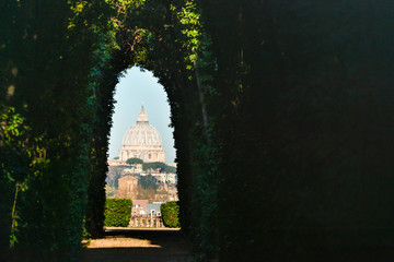 The Aventine Keyhole. Views of St Peter's Cathedral seen through peephole of door of the Priory of the Knights of Malta, Aventine Hill, Rome, Italy.