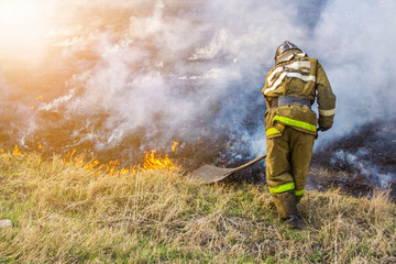 Raging forest spring fires. Burning dry grass, reed along lake. Grass is burning in meadow. Ecological catastrophy. Fire and smoke destroy all life. Firefighters extinguish Big fire. Lot of smok © Torkhov