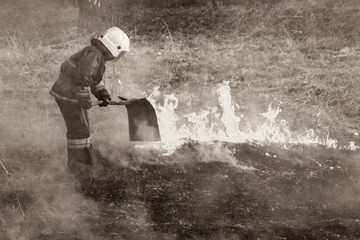 Raging forest spring fires. Burning dry grass, reed along lake. Grass is burning in meadow. Ecological catastrophy. Fire and smoke destroy all life. Firefighters extinguish Big fire. Lot of smok © Torkhov