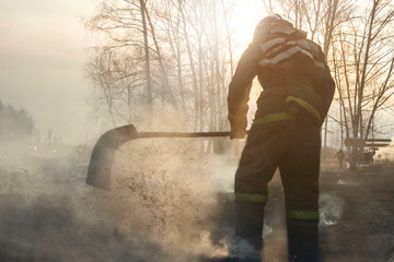 Raging forest spring fires. Burning dry grass, reed along lake. Grass is burning in meadow. Ecological catastrophy. Fire and smoke destroy all life. Firefighters extinguish Big fire. Lot of smok