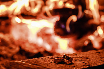 Wedding rings against the background of fire
