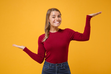 Smiling young blonde woman girl in casual clothes posing isolated on yellow orange background....