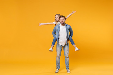 Fototapeta na wymiar Funny bearded man with child baby girl. Father little kid daughter isolated on yellow background. Love family parenthood childhood concept. Giving piggyback ride to joyful sit on back spreading hands.