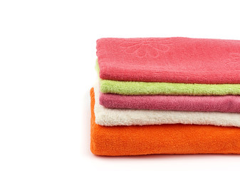 Obraz na płótnie Canvas stack of colored cotton terry folded towels on a white background