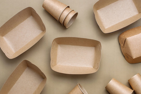 Brown kraft paper food containers on beige background