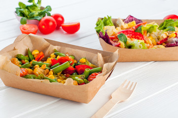 Close up of vegetable salad in the brown kraft paper food container