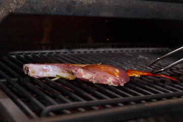 Sef roasts grilled meat. Close-up