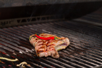 Sef roasts grilled meat. Close-up